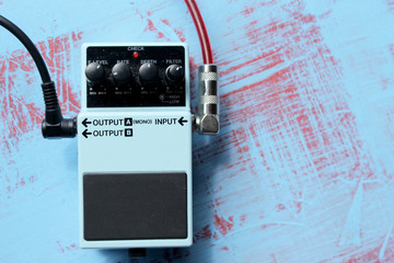 Guitar pedal on grunge background 