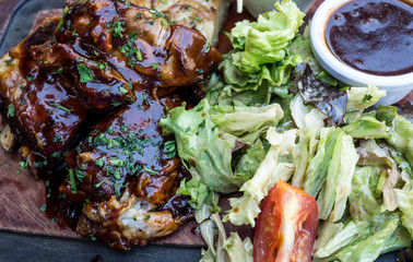 Grilled steak - Grilled meat ribs on the plate with hot sauce