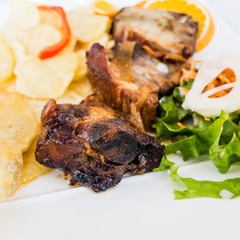 Grilled steak - Grilled meat ribs on the plate with hot sauce