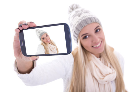 beautiful blond woman in winter clothes taking selfie photo with