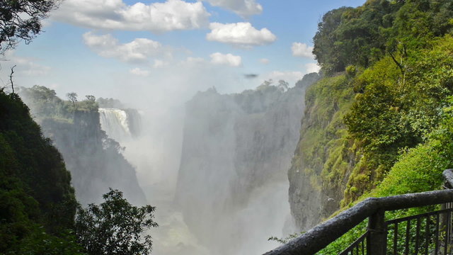 Victoria Falls Devils Cataract or Mosi-oa-Tunya waterfall in southern Africa on the Zambezi River at the border of Zambia and Zimbabwe in high definition footage with ambient audio. 
