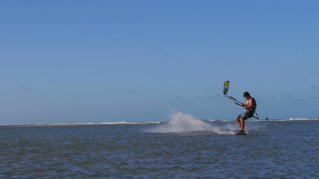 Male kiteboarder jumping