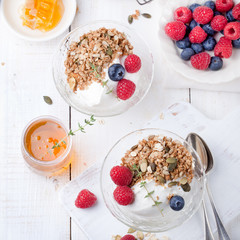 Healthy breakfast. Granola with pumpkin seeds, honey, yogurt, fresh berries .