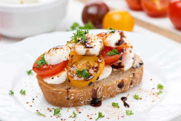 piece of ciabatta with mozzarella and colorful cherry tomatoes