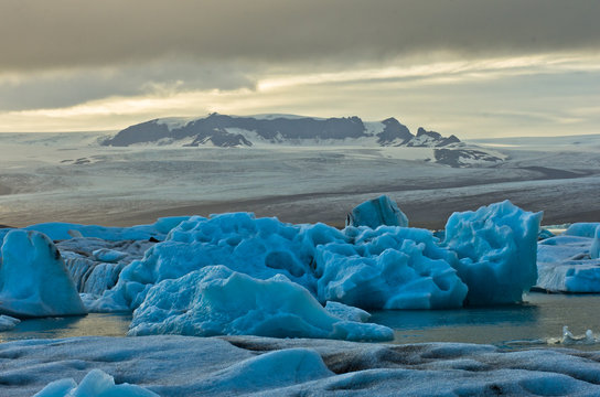 Melting of icebergs at Jokulsarlon glacier lagoon at sunset