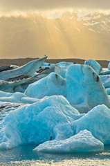 Melting of icebergs at Jokulsarlon glacier lagoon at sunset