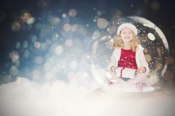 Composite image of festive child in snow globe