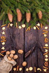 Fir cones, cracker and walnuts on a wooden background