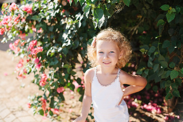 Little girl near the blooming tree
