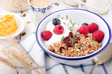 Healthy breakfast. Granola with pumpkin seeds, honey, yogurt ,fresh berries.