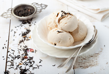 Ice cream with Earl grey tea flavor. White ceramic bowl 