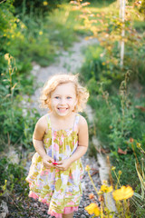 Portrait of a little girl walking in the garden - 95010995