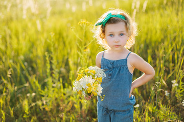 Portrait of a little girl walking in the field