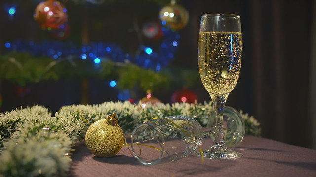 New Year and Christmas Celebration with Champagne. Wineglasses of Sparkling Wine. Holiday Decorations