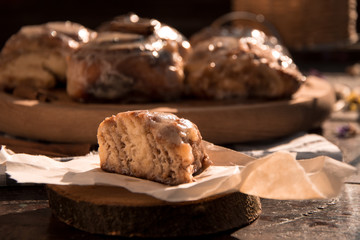 Cinnabon buns with cinnamon on a wooden board