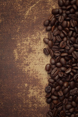 Dark roasted coffee beans on shabby chic surface