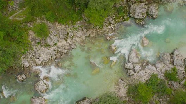 AERIAL: Flying above turquoise river in the mountains
