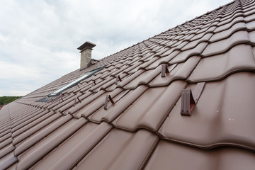 New roof with skylight, natural red tile and chimney with snow stopers