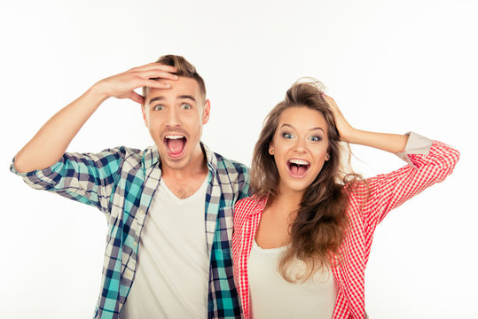 Pretty funny cheerful couple  showing surprise