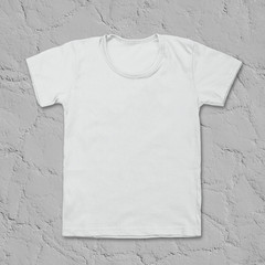 White blank t-shirt on dark stone desk