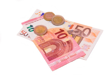 Euro banknotes and coins on a white background