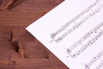 Sheet music for piano on a wooden table