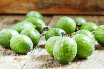 Fresh green feijoa on the old wooden background, selective focus