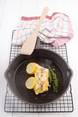 grilled cod with lemon and thyme in a pan