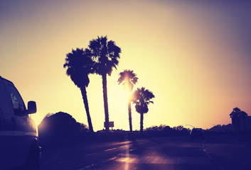 Vintage stylized picture of road against sunset, USA.