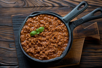 Bolognese sauce in a frying pan, above view, studio shot