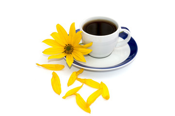 still life cup of coffee, yellow flower and nearby petals, isola