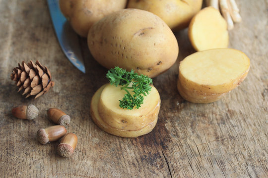 fresh potatoes on wood background