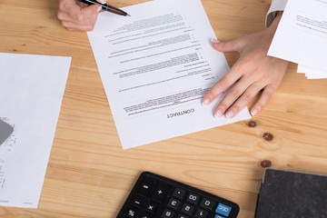 woman thinking about signing a contract