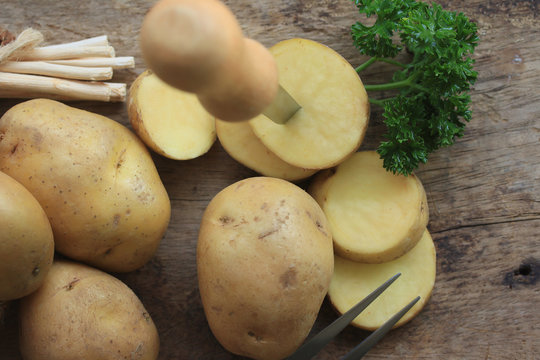 fresh potatoes on wood background