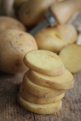 fresh potatoes on wood background