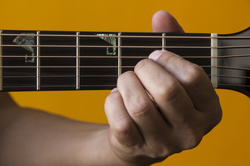 Hand performing A chord on guitar
