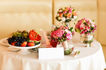 Obraz na płótnie Canvas Fruit stil vase with flowers white tablecloth