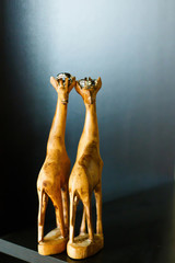 Gold wedding rings on their heads wooden sculptures giraffe