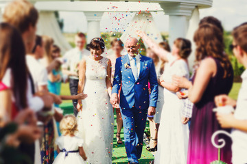 Guests Throwing Confetti Over Bride And Groom