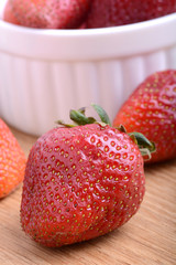 Strawberry set on wooden plate close up