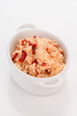 porcelain pan with homemade rice cooked with peppers and cod cru