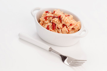 porcelain pan with homemade rice cooked with peppers and cod cru