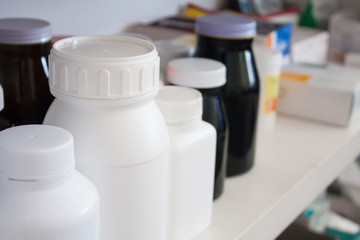 Bottles of pills arranged on shelf at drugstore