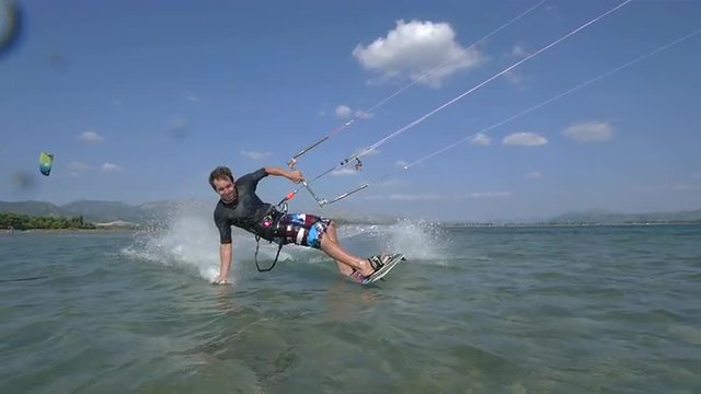 SLOW MOTION: Kiteboarder having fun kiting