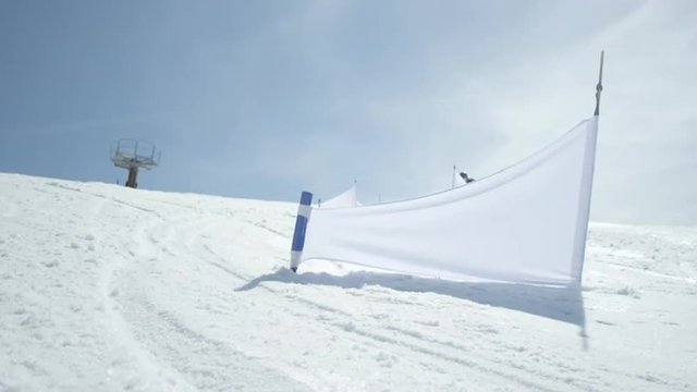 SLOW MOTION CLOSEUP: Race snowboarding riding slalom