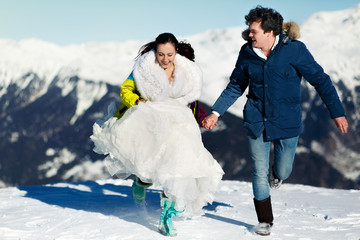 Fototapeta na wymiar bride and groom in love runing background of the Alps Courchevel