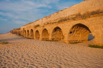 Ancient Roman aqueduct at sunset