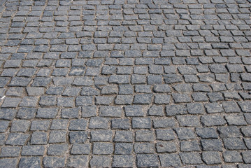 Abstract background of old cobblestone pavement close-up