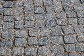 Abstract background of old cobblestone pavement close-up