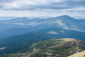 Fototapeta premium View of misty mountains in summer Carpathians, Ukraine